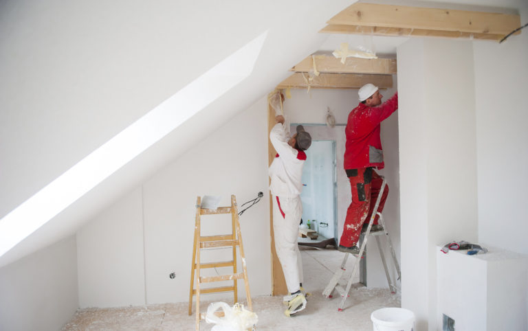 two house painters applying paint to the interior walls and ceiling of a residential property Sydney